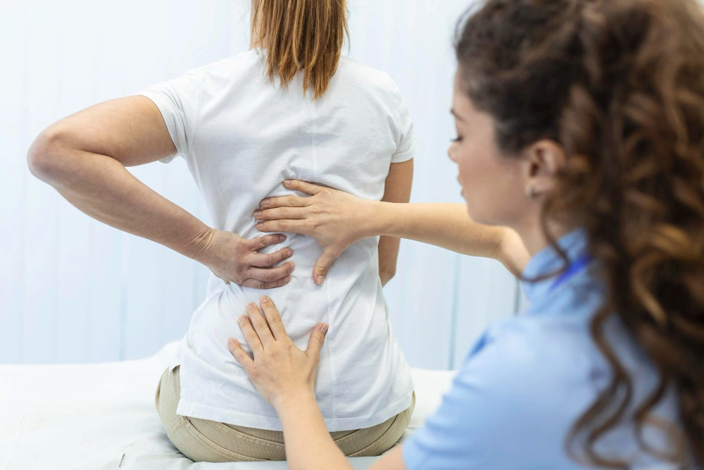 Chiropractor checking sciatica pain points on female patient