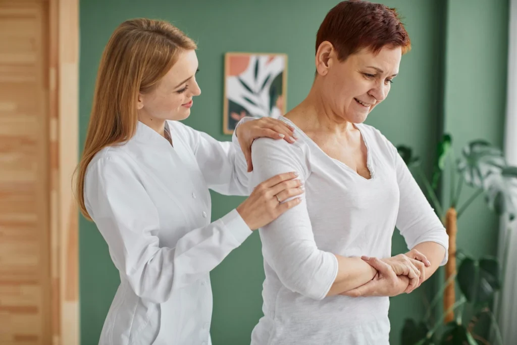 Chiropractor with female patient listening to health history