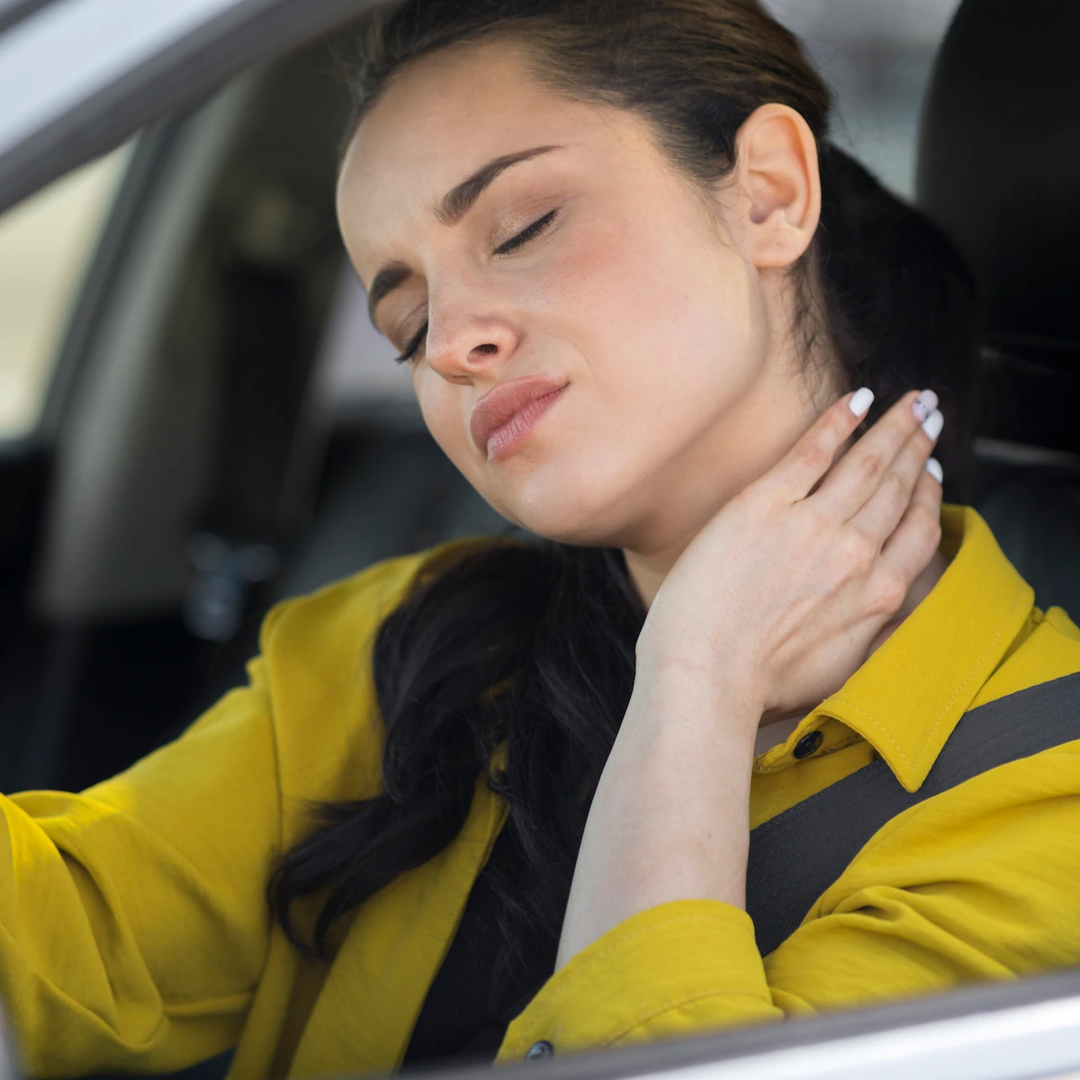 Woman holding her neck from auto accident injury