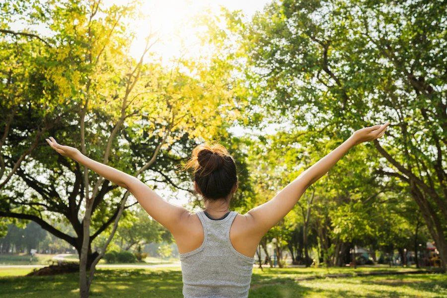 Woman practicing meditation outdoors representing holistic wellness approach in Crawfordsville