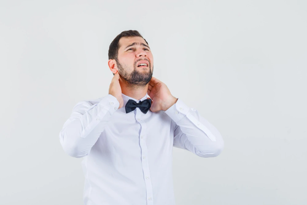 Person experiencing neck pain from smartphone use and poor posture