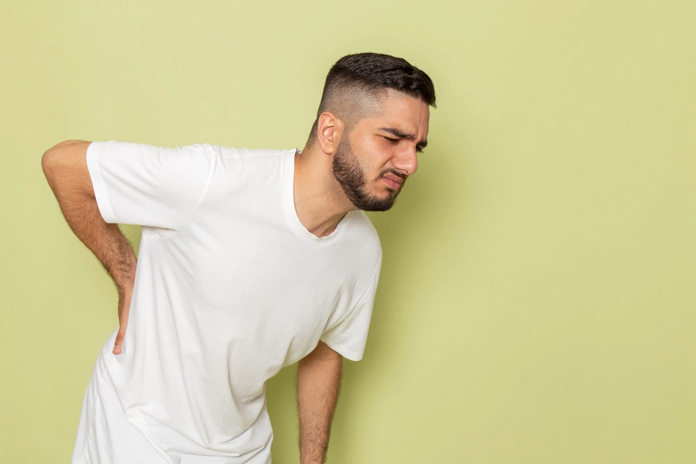 Person experiencing lower back pain from disc issues