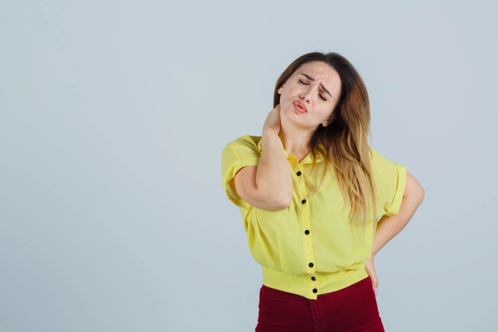 Person holding neck or back due to pinched nerve pain
