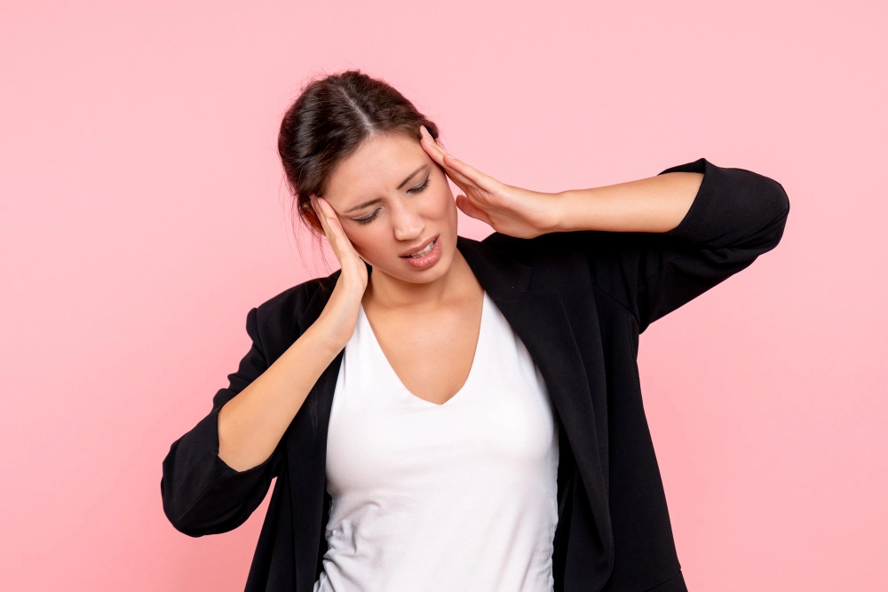 Woman holding neck due to stress-related tension and pain